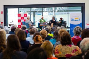 Crowd shot with panellists on stage 