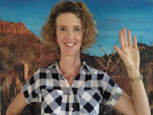 Cristy Burne with her hand raised