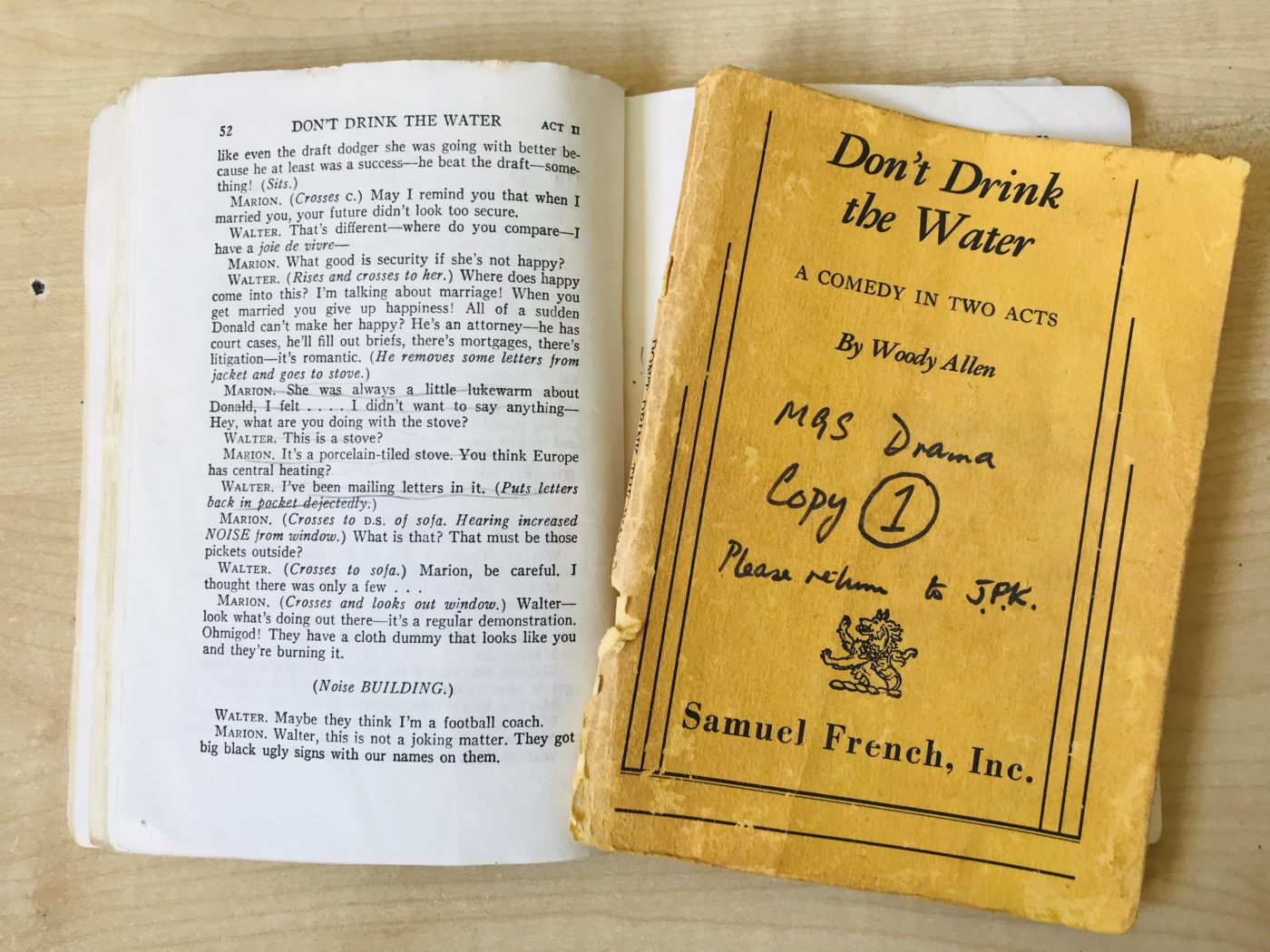 Image of a open book wiith a yellow piece of paper in the middle
