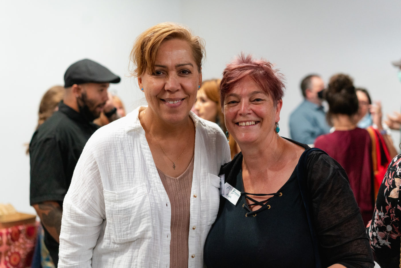 Author Cheryl Kickett-Tucker stand side by side with an emerging writers program participant smiling