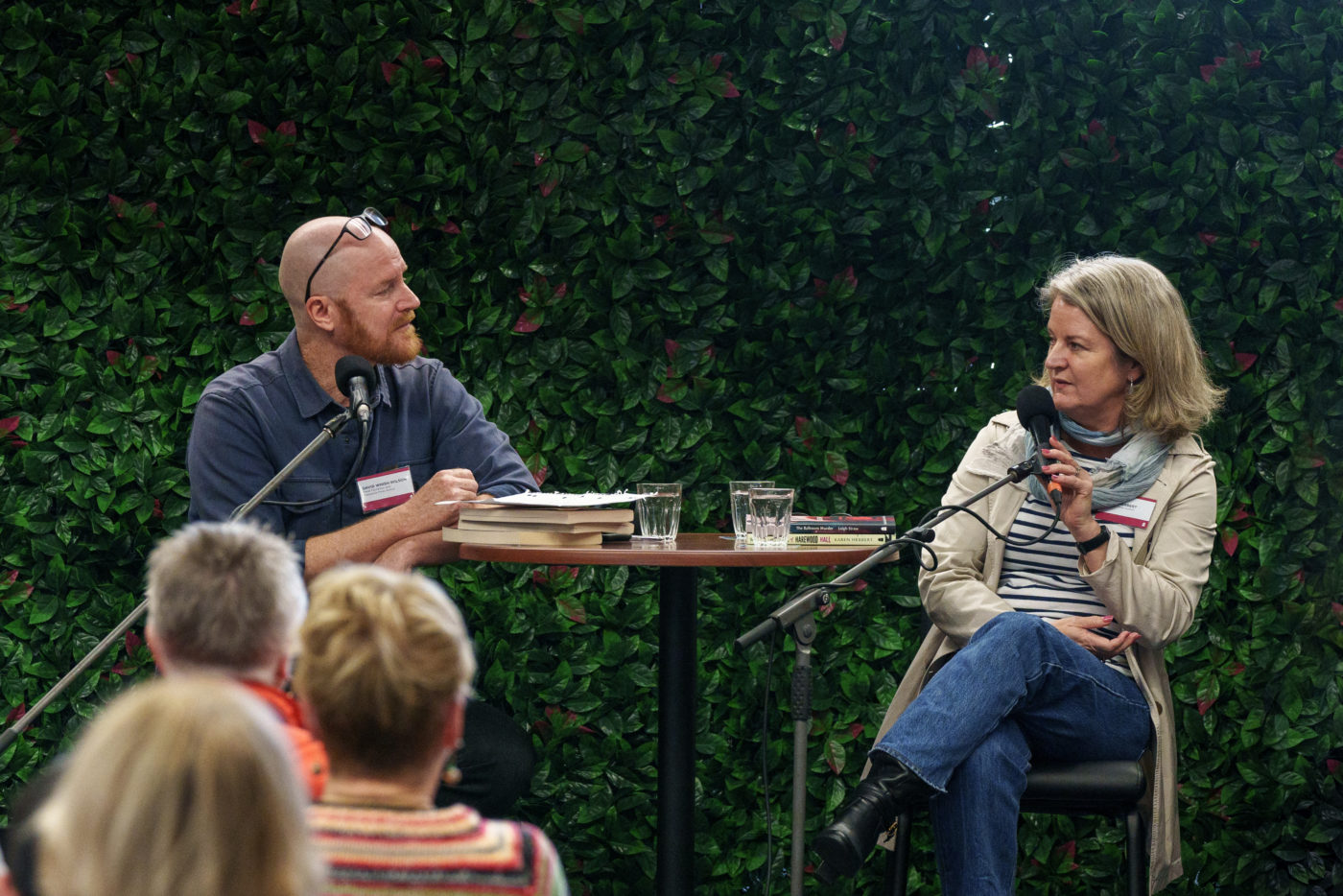 David Whish-Wilson and Karen Herbert sitting on high chairs speaking into microphones 